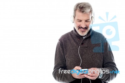 Handsome Man Enjoying Music On His Mobile Stock Photo