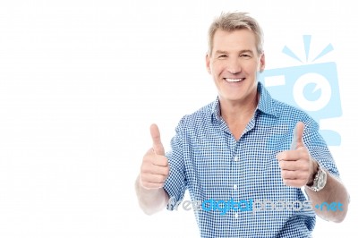 Handsome Man Gesturing Double Thumbs Up Stock Photo