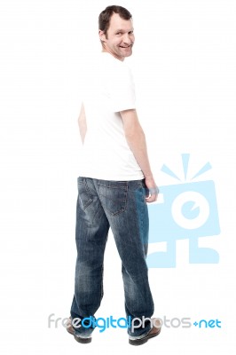 Handsome Man In Jeans Standing Back Stock Photo