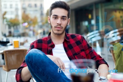 Handsome Man Looking At Camera At Coffee Shop Stock Photo