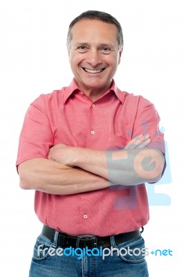 Handsome Man Posing With Arms Folded Stock Photo