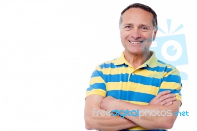 Handsome Man Posing With Arms Folded Stock Photo