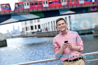 Handsome Man Texting On A Mobile Phone Stock Photo