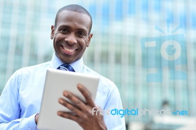 Handsome Man Using His Tablet Computer Stock Photo