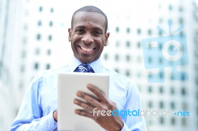 Handsome Man Using His Tablet Computer Stock Photo