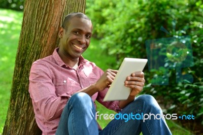 Handsome Man With Tablet In The Park Stock Photo