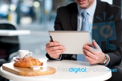 Handsome Manager Using His Tablet Device Stock Photo