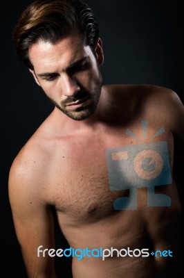 Handsome Muscular Male Model Posing Over Black Background Stock Photo