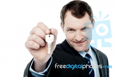 Handsome Realtor Offering House Key Stock Photo