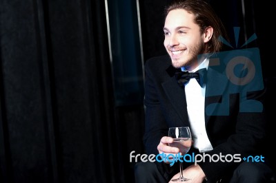 Handsome Smiling Man Holding A Glass Of Wine Stock Photo