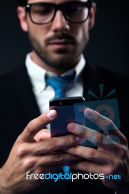 Handsome Stylish Man In Elegant Black Suit Using Mobile Phone Stock Photo