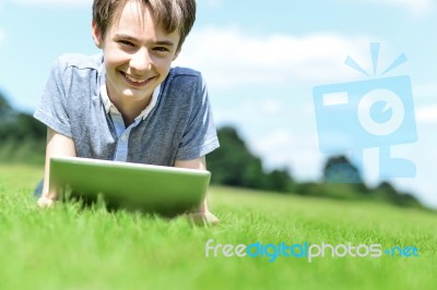 Handsome Young Boy With Tablet Device, Outdoors Stock Photo