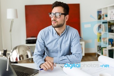 Handsome Young Businessman Working In The Office Stock Photo