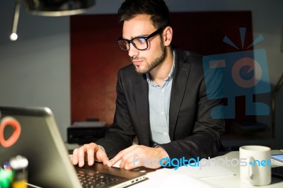 Handsome Young Businessman Working With Laptop In The Office Stock Photo