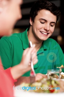 Handsome Young Guy Enjoying Meal In Restaurant Stock Photo