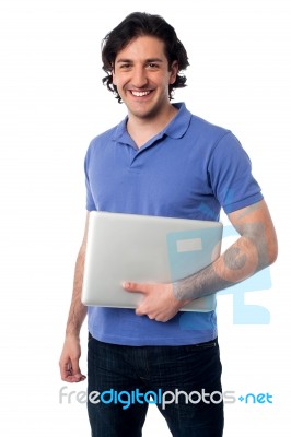 Handsome Young Male Holding Laptop Stock Photo