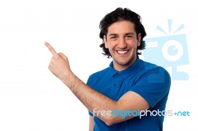 Handsome Young Male Pointing At Something Stock Photo