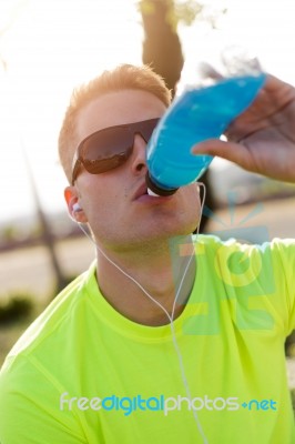 Handsome Young Man Drinking After Running Stock Photo