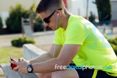 Handsome Young Man Listening To Music After Running Stock Photo