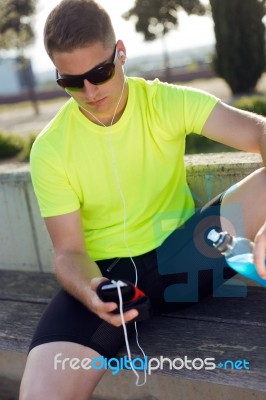 Handsome Young Man Listening To Music After Running Stock Photo