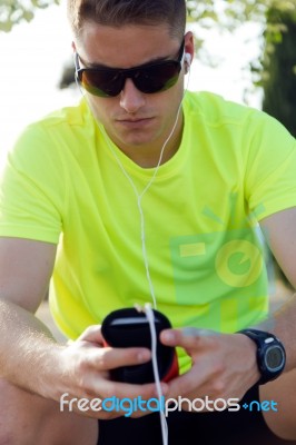 Handsome Young Man Listening To Music After Running Stock Photo