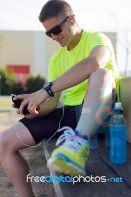 Handsome Young Man Listening To Music After Running Stock Photo