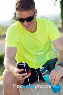 Handsome Young Man Listening To Music After Running Stock Photo