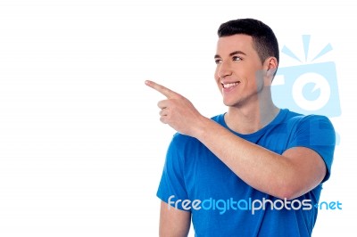 Handsome Young Man Pointing Away Stock Photo