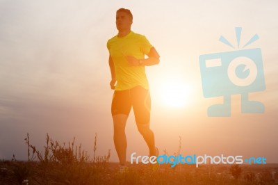 Handsome Young Man Running In The Park Stock Photo