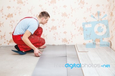 Handyman Laying Down Laminate Flooring Boards Stock Photo