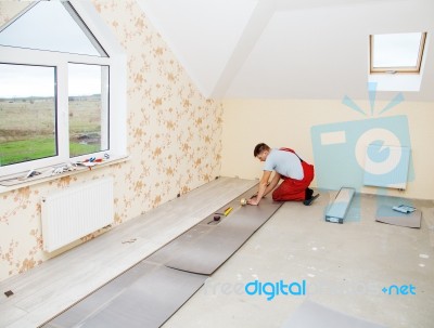 Handyman Laying Down Laminate Flooring Boards Stock Photo