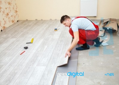 Handyman Laying Down Laminate Flooring Boards Stock Photo