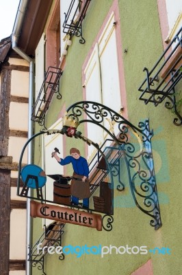 Hanging Sign In Riquewihr In Haut-rhin Alsace France Stock Photo