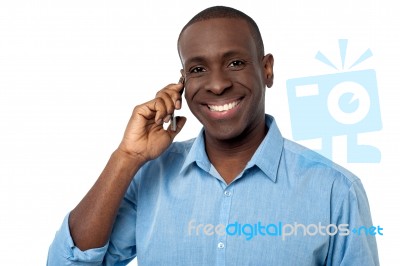 Happy African Guy Attending A Phone Call Stock Photo