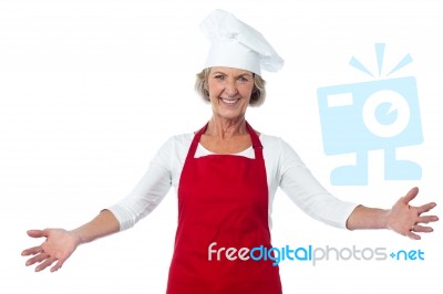 Happy Aged Chef Gesturing Welcome Stock Photo