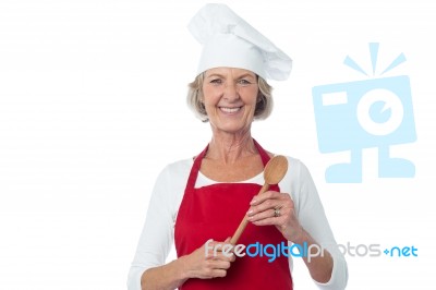 Happy Aged Chef Holding Wooden Spoon Stock Photo