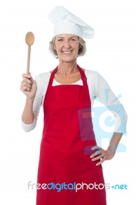 Happy Aged Chef Holding Wooden Spoon Stock Photo