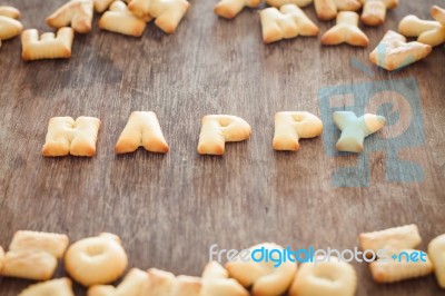 Happy Alphabet Biscuit On Wooden Table Stock Photo