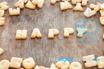 Happy Alphabet Biscuit On Wooden Table Stock Photo