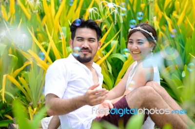 Happy Asian Couple Play Together With Bubble Garden Stock Photo