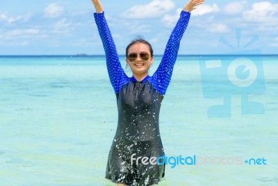 Happy Asian Teen Girl Play Splashing Water In The Sea Stock Photo