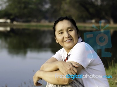 Happy Asian Woman In The Park Stock Photo