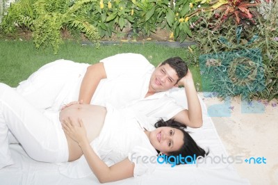 Happy Beautiful Pregnant Woman With His Husband Outdoors Stock Photo