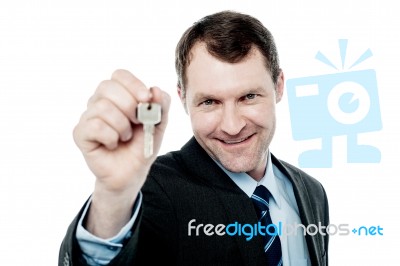 Happy Businessman Holding A House Key Stock Photo