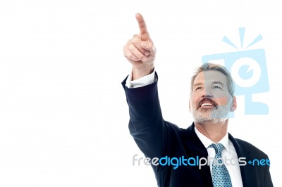 Happy Businessman Pointing At Copyspace Stock Photo