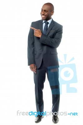 Happy Businessman Pointing At Something Stock Photo