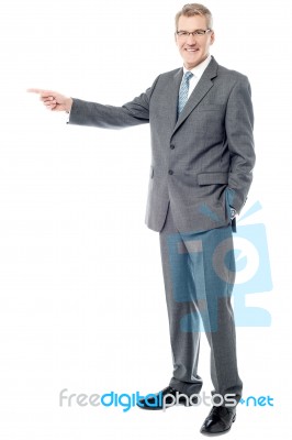 Happy Businessman Pointing On Copy Space Stock Photo