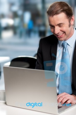 Happy Businessman Working On Laptop Stock Photo