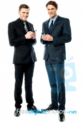 Happy Businessmen Using Cellphone Stock Photo