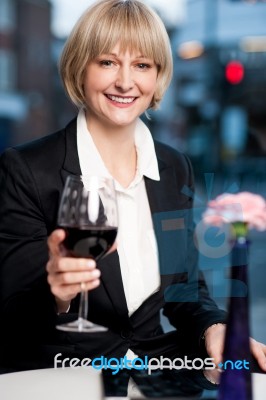 Happy Businesswoman Holding Wine Glass Stock Photo